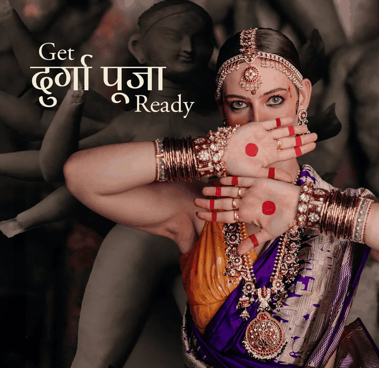 Woman wearing traditional Durga Puja jewellery with layered necklaces, bangles and a purple saree in Mortantra festive campaign