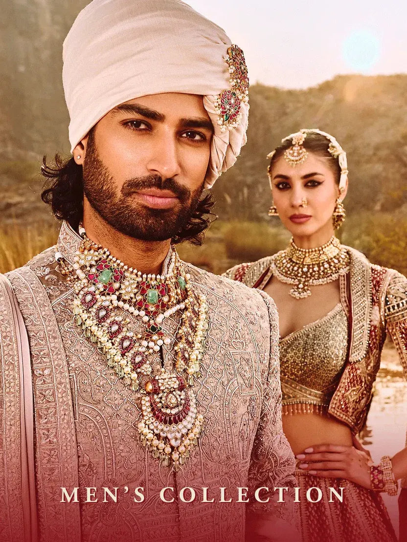 Indian groom wearing layered traditional wedding necklaces with gemstones and pearls by Mortantra