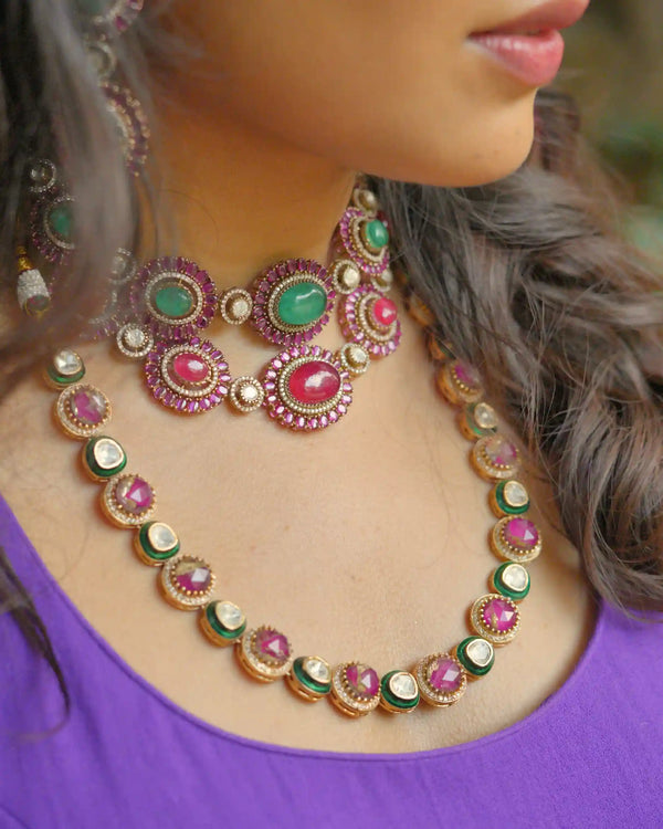 Close-up of a person wearing an ornate necklace with gemstones on a blurred background