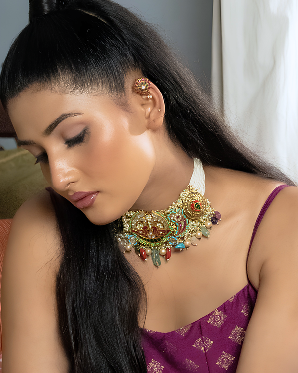 Woman wearing a decorative necklace and earrings indoors